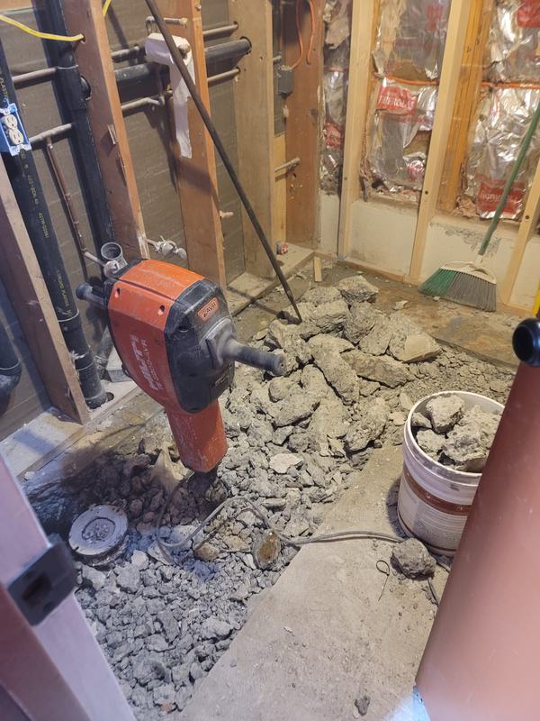 Jackhammer breaking up the bathroom slab
