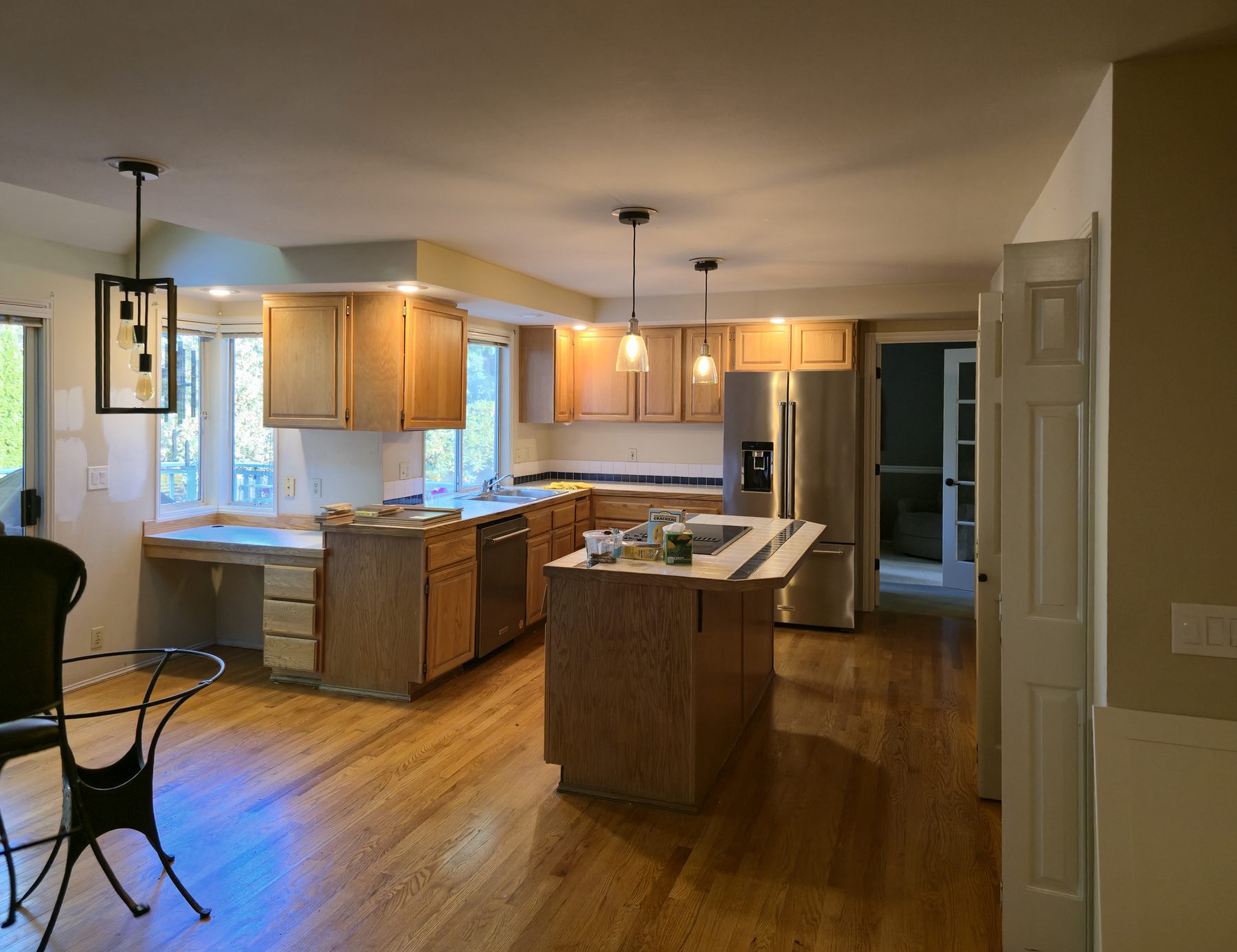 Before: oak kitchen with tile counters and a small island